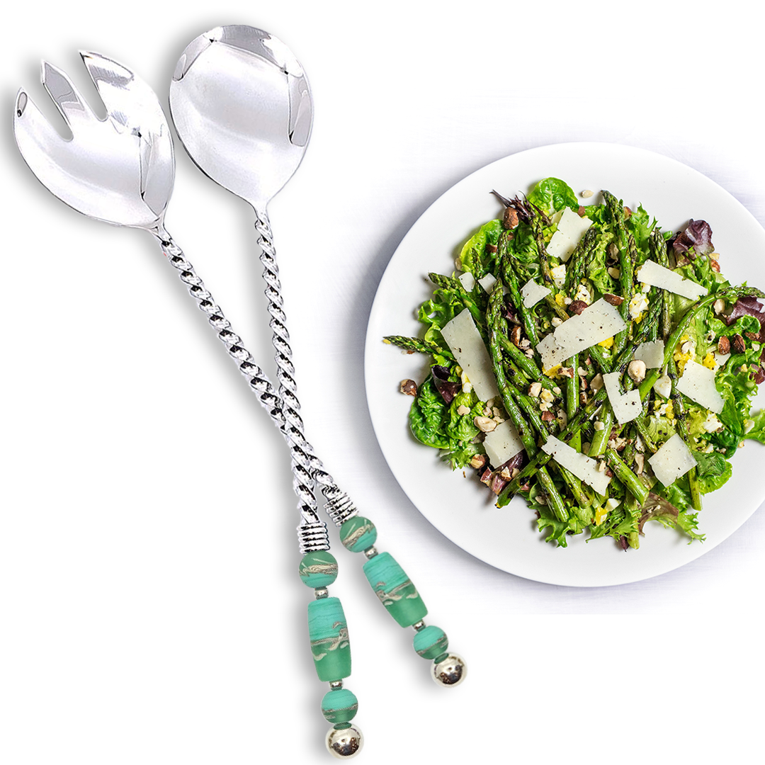 Handcrafted salad servers with twisted handles adorned with delicate glass bead embellishments, offering a unique twist on traditional serving utensils. Crafted with artisanal craftsmanship and exquisite design, providing functionality and elegance for formal dinners or casual meals. Pictured with an asparagus salad.