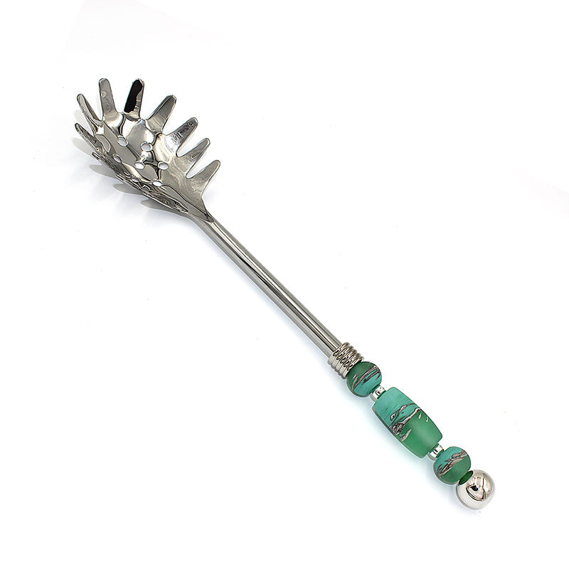 Handmade stainless steel pasta server with delicate glass bead embellishments along the handle.